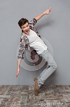 Full length portrait of excited dancing young man Stock Photo
