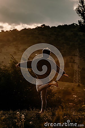 Fashion shot of a talented hip hop dancer while dancing at mountain meadow Stock Photo