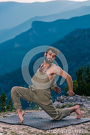 Fashion shot of a talented hip hop dancer while dancing at mountain peak Stock Photo