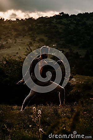 Fashion shot of a talented hip hop dancer while dancing at mountain Stock Photo