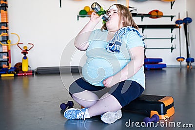 Exhausted Overweight Woman in Gym Stock Photo