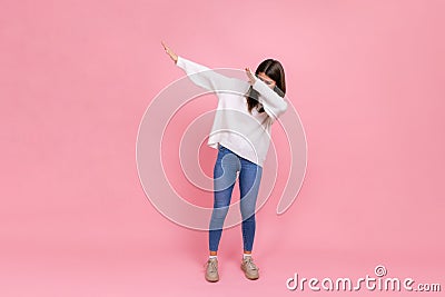 Full length portrait of female shows internet meme pose, celebrating success victory, dabbing trends Stock Photo