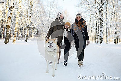 Family Walking Dog in Winter Stock Photo