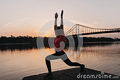 Full-length portrait of happy slim girl doing yoga on nature background. Outdoor shot of pleased la Stock Photo