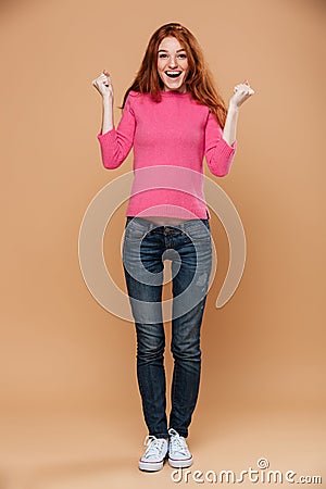 Full length portrait of a joyful young redhead girl Stock Photo