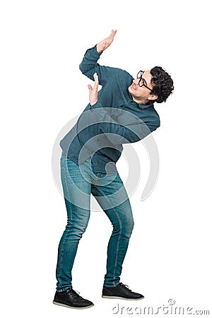 Full length portrait scared man keeps hands raised up to protect him from any danger, isolated over white background. Nerd Stock Photo