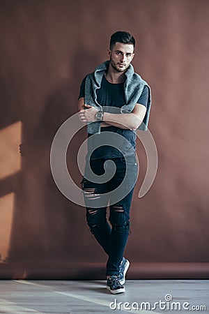 Full length portrait of a muscular man with crossed arms po Stock Photo