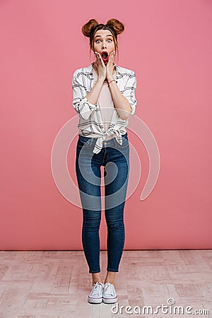 Full length portrait of a shocked young girl screaming Stock Photo