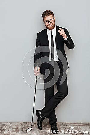 Full length portrait of a smiling bearded businessman in suit Stock Photo