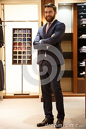 Full length portrait of smiling man with crossed arms Stock Photo