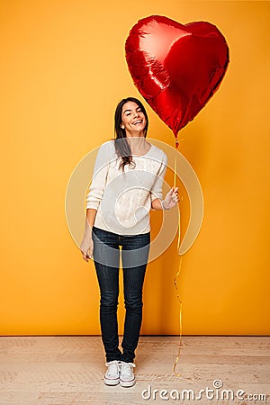 Full length portrait of a smiling young woman Stock Photo