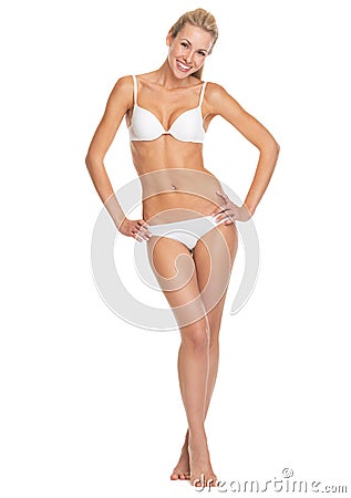 Full length portrait of smiling young woman in lingerie Stock Photo