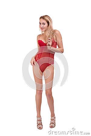 Full length portrait of young beautiful blonde woman in red underwear posing isolated over white background Stock Photo