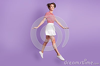 Full length profile photo of lady jump motion white smile wear striped t-shirt mini skirt footwear purple color Stock Photo