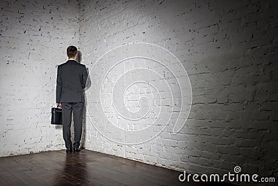 Full length rear view of businessman standing in corner at office Stock Photo