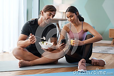Your diet is just as important as your workout. Full length shot of an athletic young couple enjoying some healthy Stock Photo