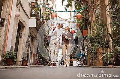 Full Length Shot Of Happy Senior Tourists Couple Walking Outdoors Stock Photo