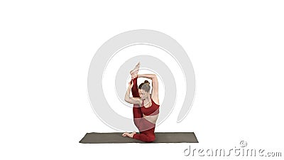 Sporty yogi girl doing fitness practice, stretches, yoga asana Parivritta Kraunchasana on white background. Stock Photo