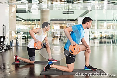 Determined young man exercising Russian twist Stock Photo