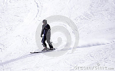 Full length of skier skiing on fresh powder snow. Man skier running downhill on sunny Alps slope Editorial Stock Photo