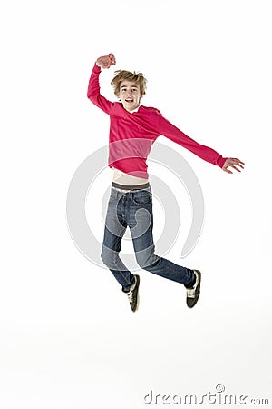 Full Length Studio Portrait Of Jumping Teenage Boy Stock Photo