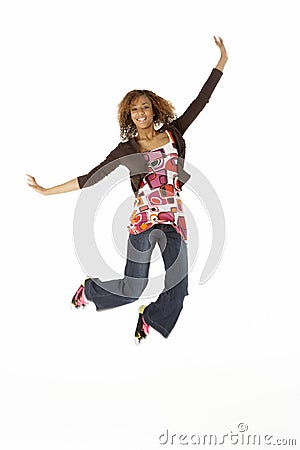 Full Length Studio Portrait Of Jumping Teenage Gir Stock Photo