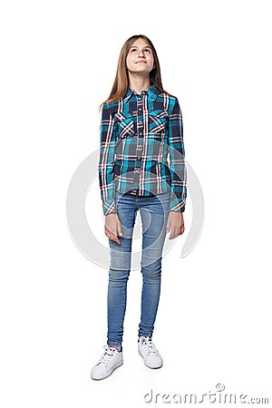 Teen girl in checkered shirt standing casually looking up Stock Photo