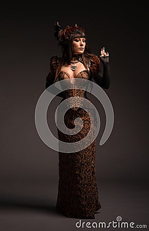 Full length view of brunette woman in gothic steampunk gown Stock Photo