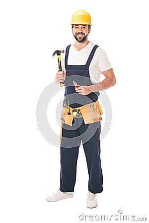 full length view of handsome repairman holding tools and smiling at camera Stock Photo