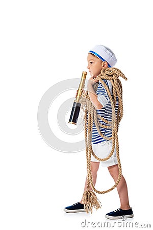 View of preschooler child in sailor suit holding spyglass and rope isolated on white Stock Photo