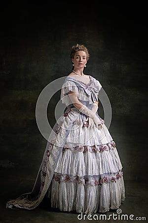 Full-length vintage portrait of young adorable girl in image of medieval royal person in renaissance style dress Stock Photo