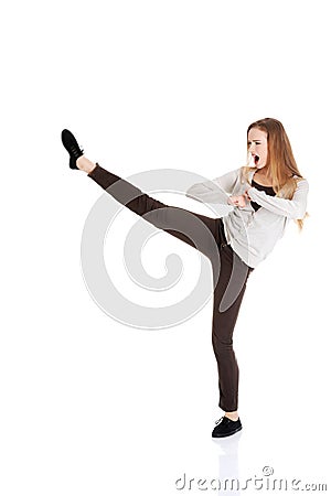 Full length woman kicking Stock Photo