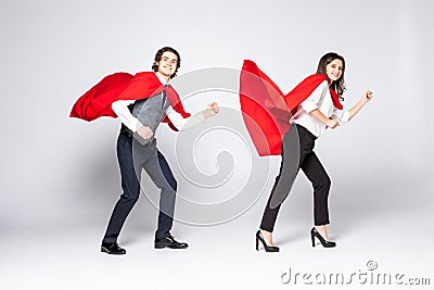 Full length of young couple wearing red superhero isolated on white background Stock Photo