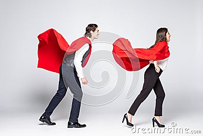 Full length of young couple wearing red superhero isolated on white background Stock Photo