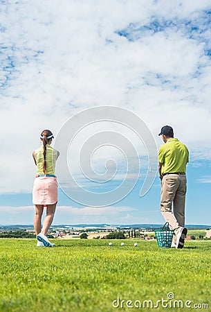 Young woman practicing the correct move during golf class Stock Photo