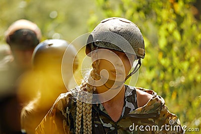 Full military experience - One day commando - running through the water with automatic rifle replica Stock Photo