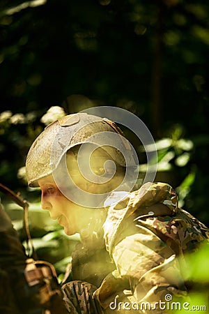 Full military experience - One day commando - running through the water with automatic rifle replica Stock Photo