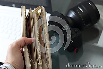 Full of money wallet hand on blur camera background Stock Photo