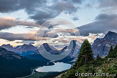 A full moon hangs over Bow Lake and Medicine Bow Peak in Banff N Stock Photo