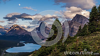 A full moon hangs over Bow Lake and Medicine Bow Peak in Banff N Stock Photo