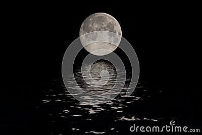 Full moon over dark black sky at night Stock Photo