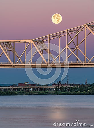 Full moon over the Ohio River and a yellow bridge. Stock Photo