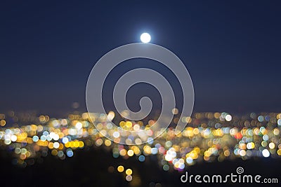 Full Moon Rise Over Blurred City Lights Landscape Stock Photo