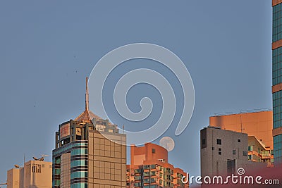 Full Moon setting behind building at hong kong 22 July 2021 F Editorial Stock Photo