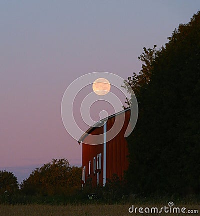 Full Moon Setting by Wisconsin Barn Stock Photo