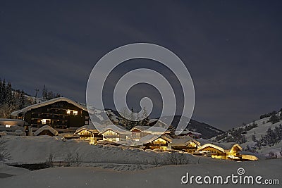 Full moon winter night fairytale, houses under snow Stock Photo