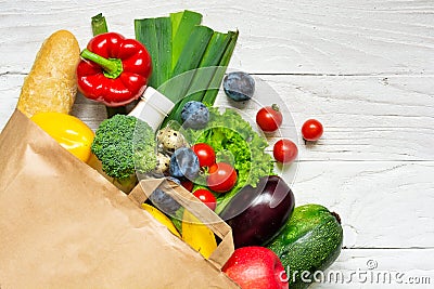 Full paper bag of different health food on white wooden background Stock Photo