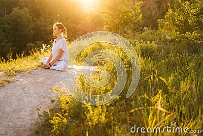 Full peace and tranquillity young woman meditating sitting in lotus position with closed eyes Stock Photo