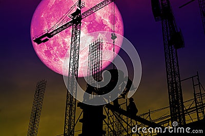 full pink moon back silhouette worker on construction building Stock Photo