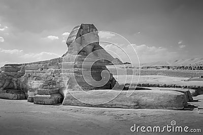 The full profile of the Great Sphinx with the pyramid in the background in Giza. Stock Photo